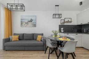 Exclusive and Modern Grey Apartment with Furnished Balcony in Kołobrzeg by Noclegi Renters